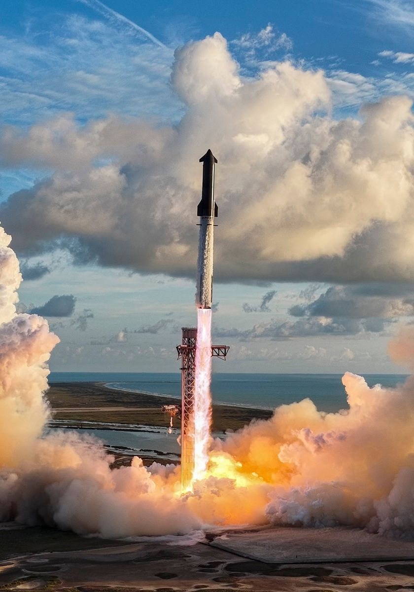 Starship lifting off from the launch tower, surrounded by huge clouds of exhaust.